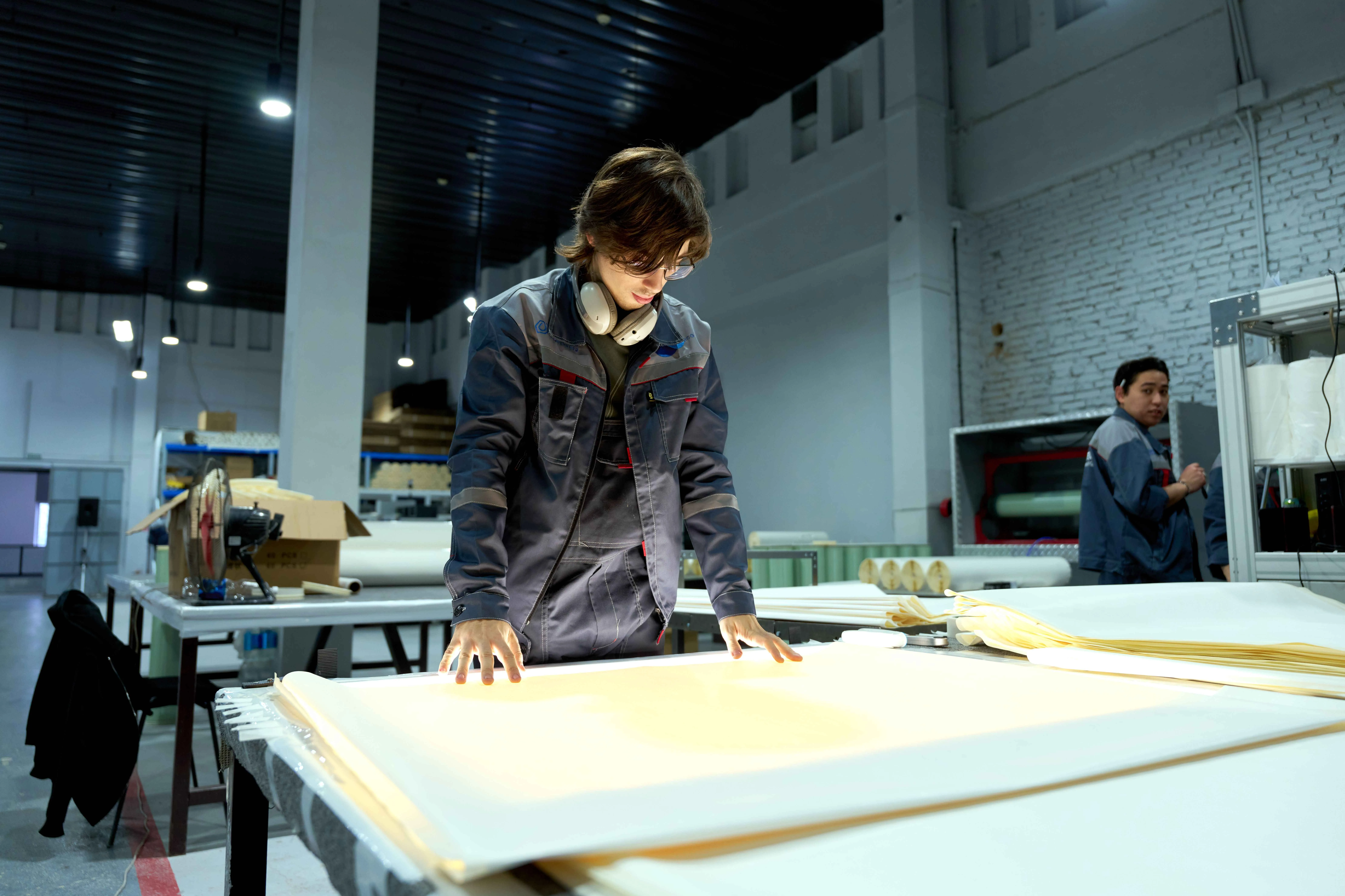 Employee supervising digital systems in an industrial control room