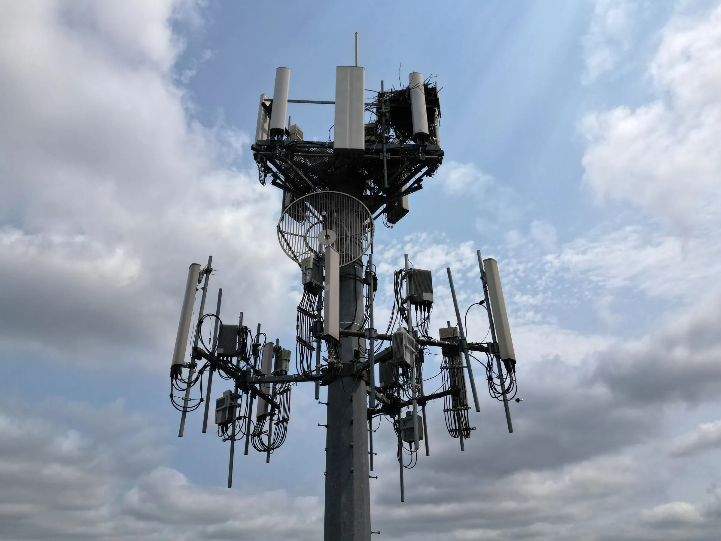 Radio antennas on a telecommunications mast against the sky