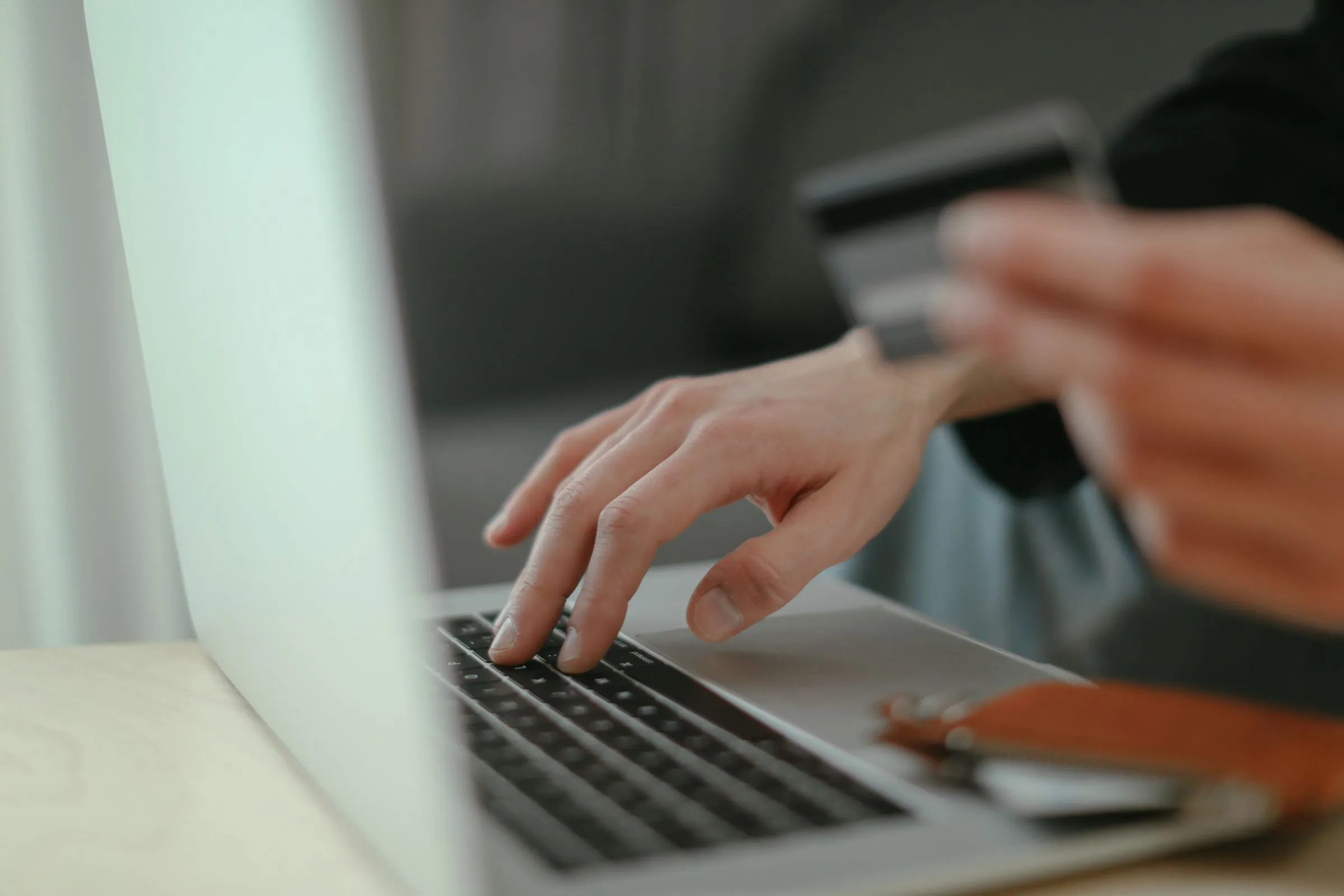 Paying with a card at a laptop checkout